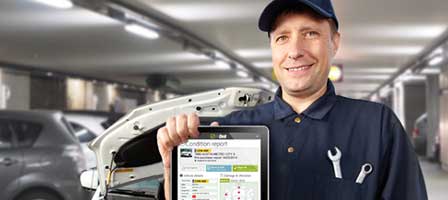 car rental mechanic checking vehicles on an iPad