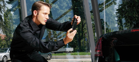 man photographing a car with a phone